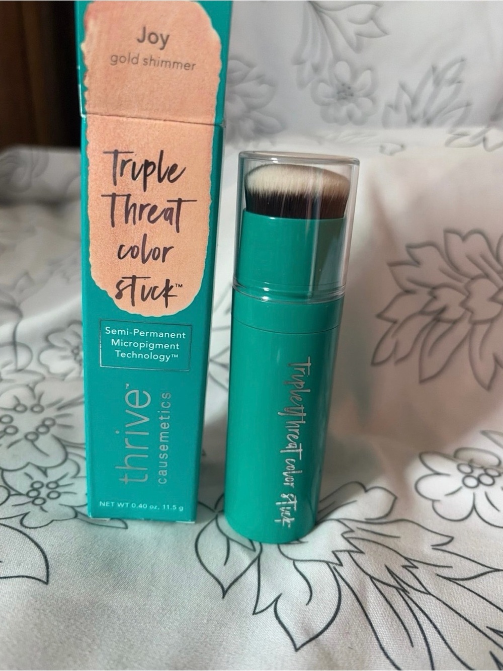 thrive causemetics Triple Threat Color Stick in Teal & Gold Shimmer